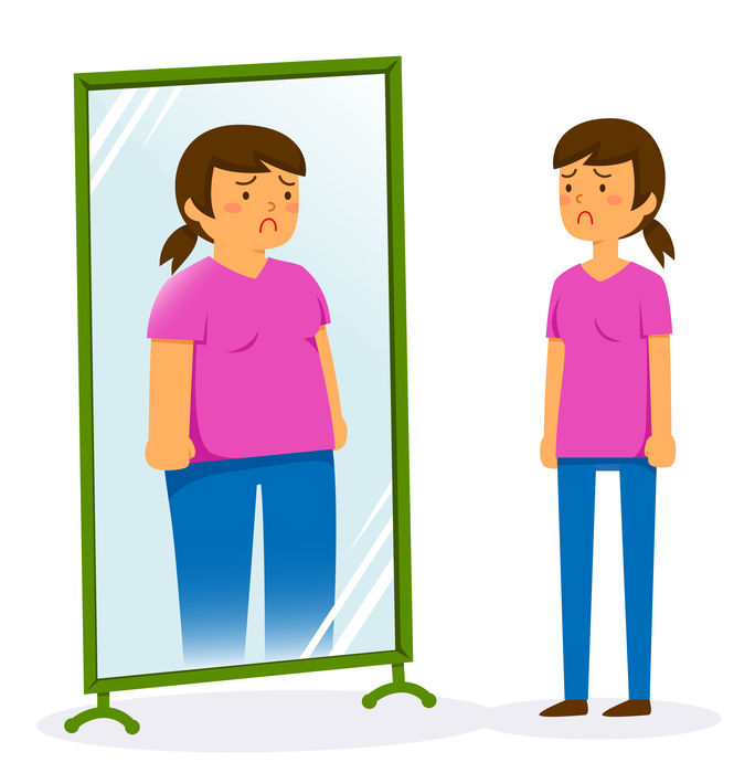 鏡の前で太ったイメージを見ている女性